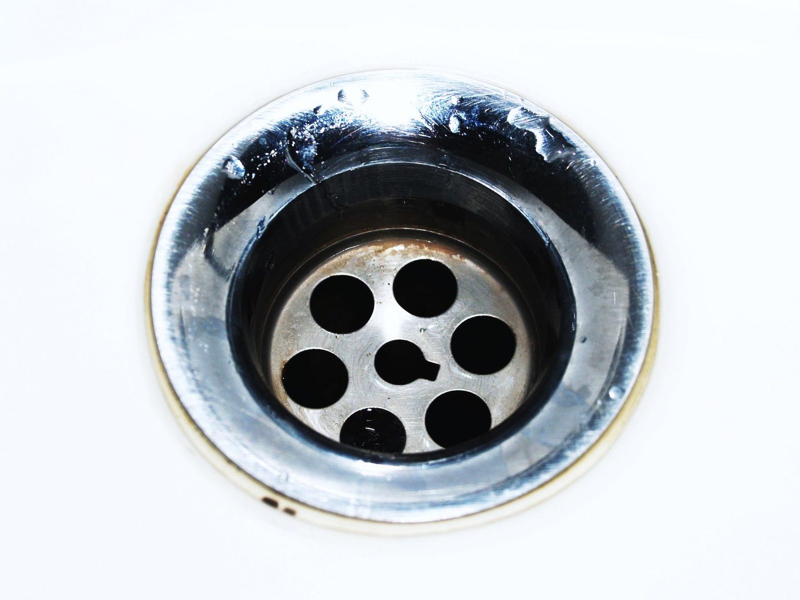 A chrome sink strainer seen from directly above